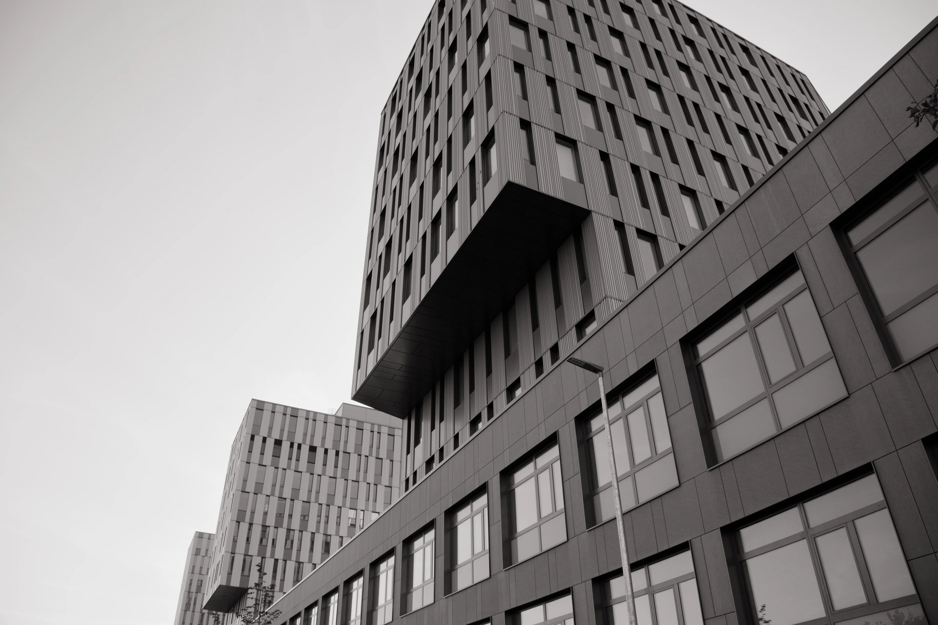 Black-and-white architecture photography of a modern office building with three towers.