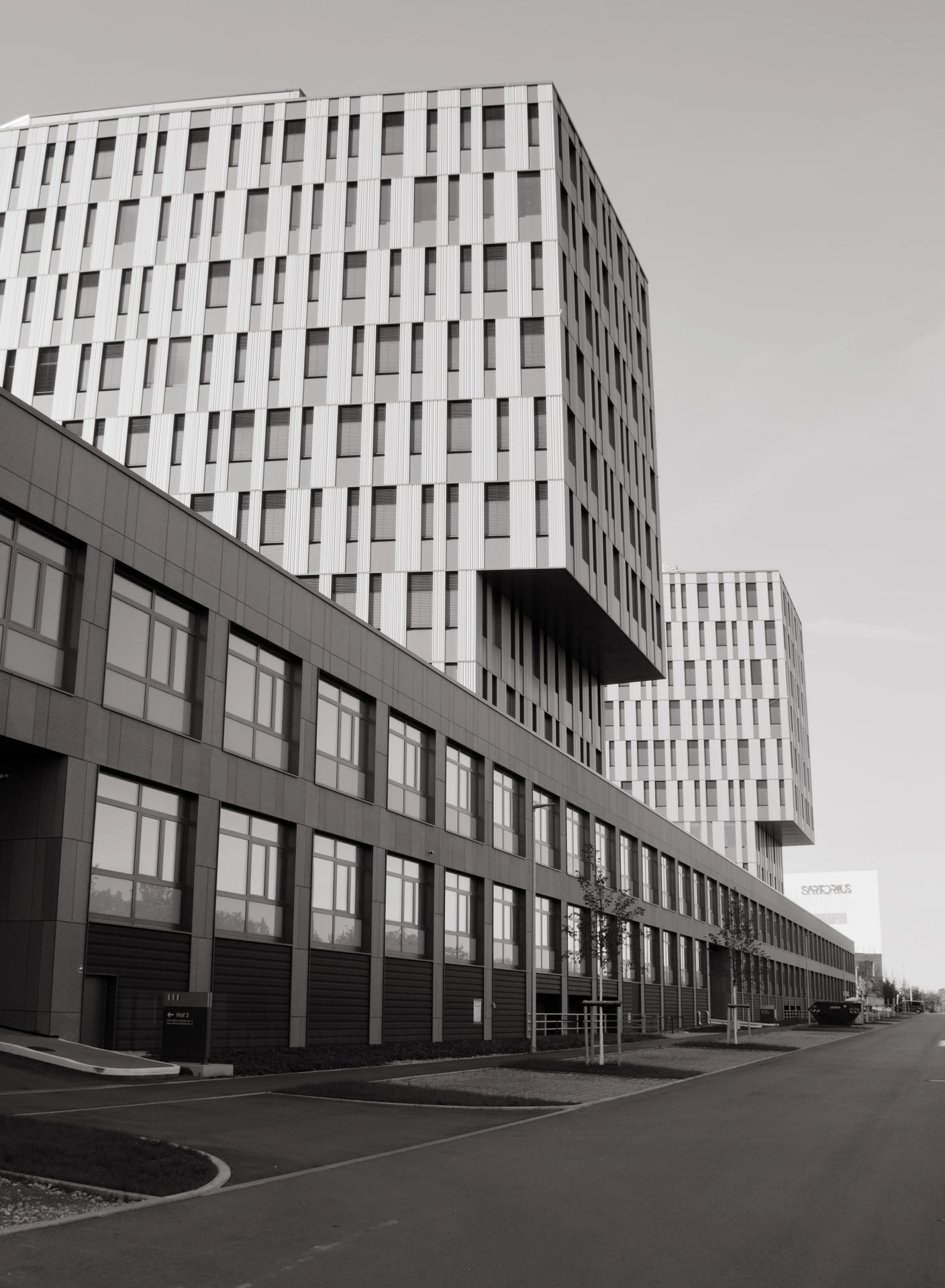Black-and-white architecture photography of a modern office building with two towers.